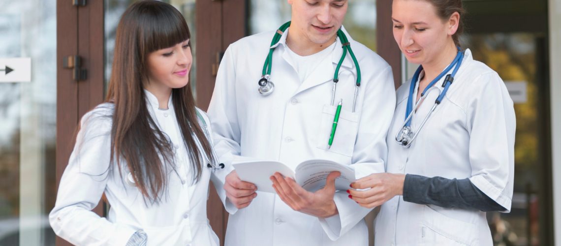 cheerful-group-medics-reading-papers